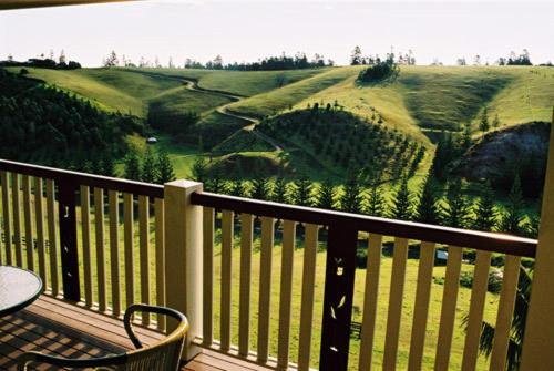 a balcony with a view of a golf course at Panorama Seaside Apartments Norfolk Island in Burnt Pine
