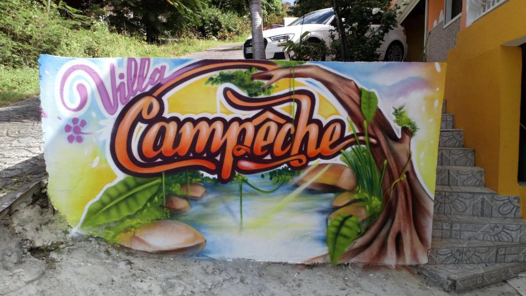 a painting of a river on the side of a building at Villa Campêche in Bouillante