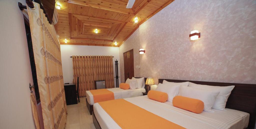 a bedroom with two beds in a room at King Reach in Anuradhapura