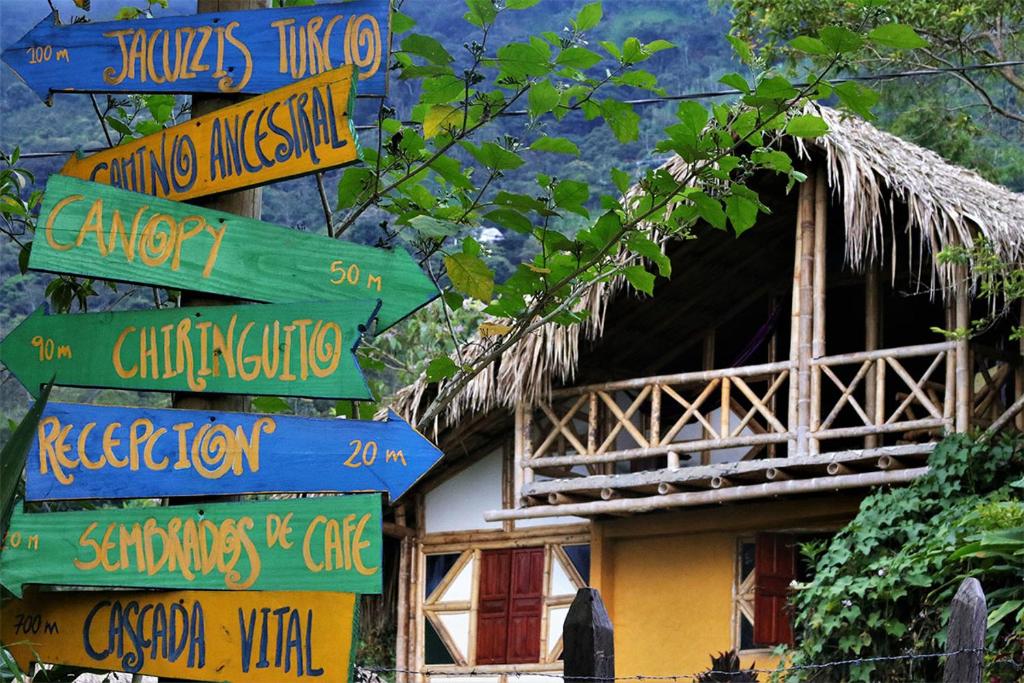 hut made of wood and straw with signs outside.