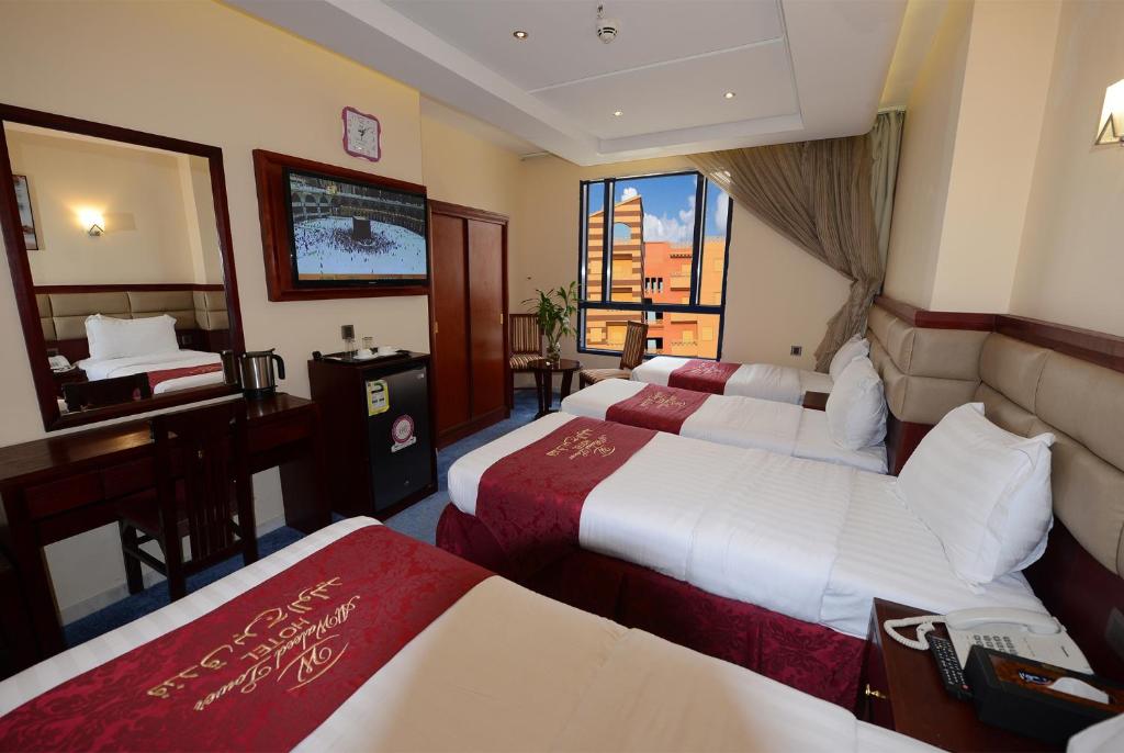 Postel nebo postele na pokoji v ubytování Al Waleed Tower Hotel