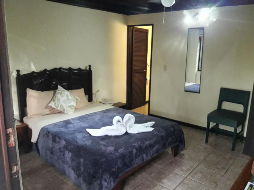 Postel nebo postele na pokoji v ubytování Hotel La Colina