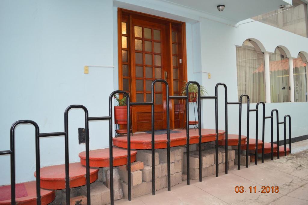 a row of benches sitting in front of a building at Residencial Belle Maison in Cusco