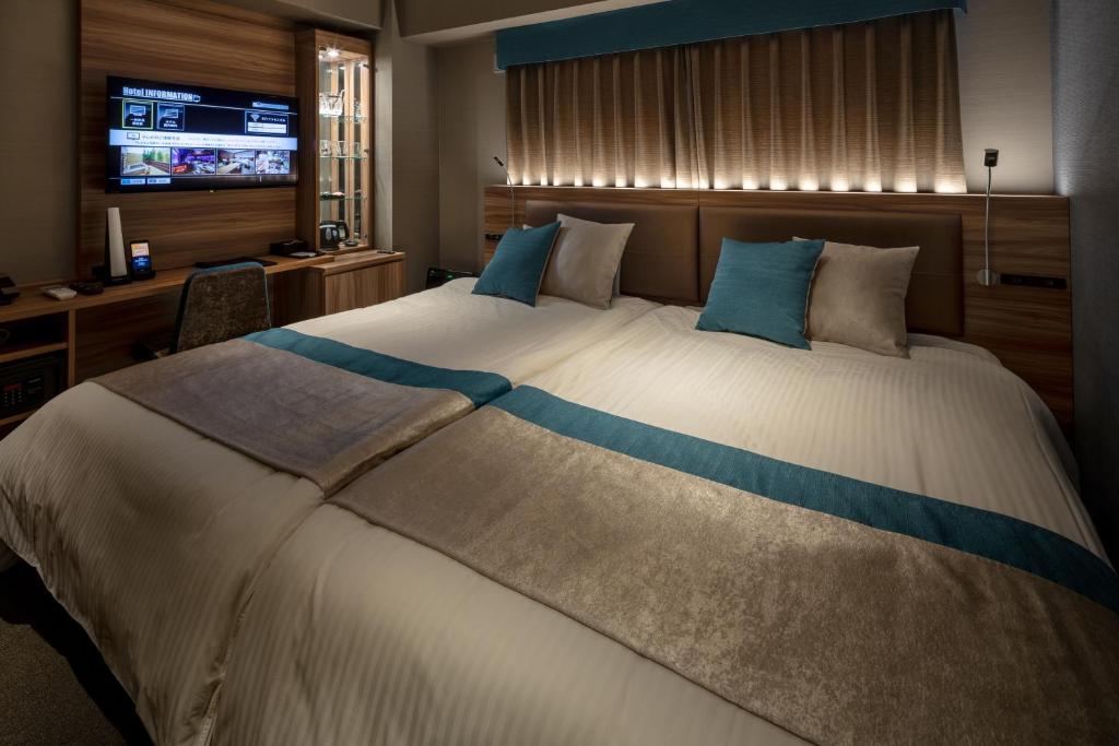 Postel nebo postele na pokoji v ubytování Wat Hotel & Spa Hida Takayama
