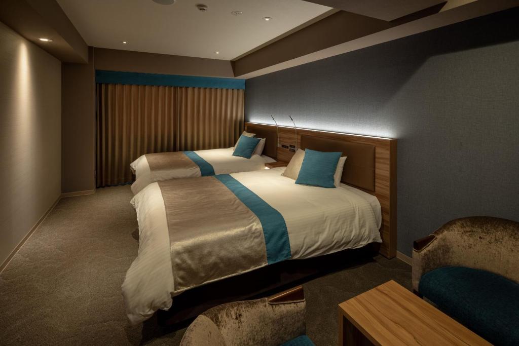 Postel nebo postele na pokoji v ubytování Wat Hotel & Spa Hida Takayama