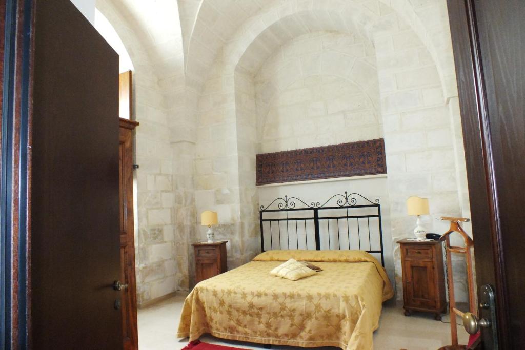 Кровать или кровати в номере Masseria Gattamora