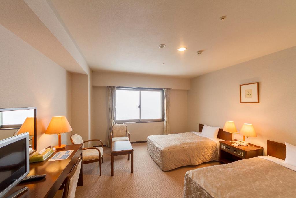 Postel nebo postele na pokoji v ubytování Midagahara Hotel