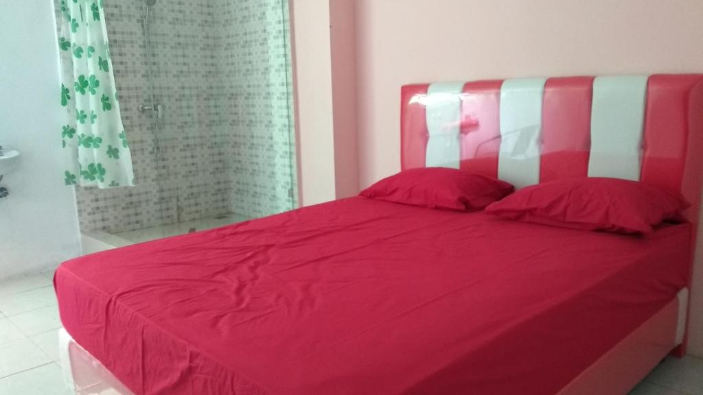 Postel nebo postele na pokoji v ubytování Uni Inn Semarang - Gunung Pati