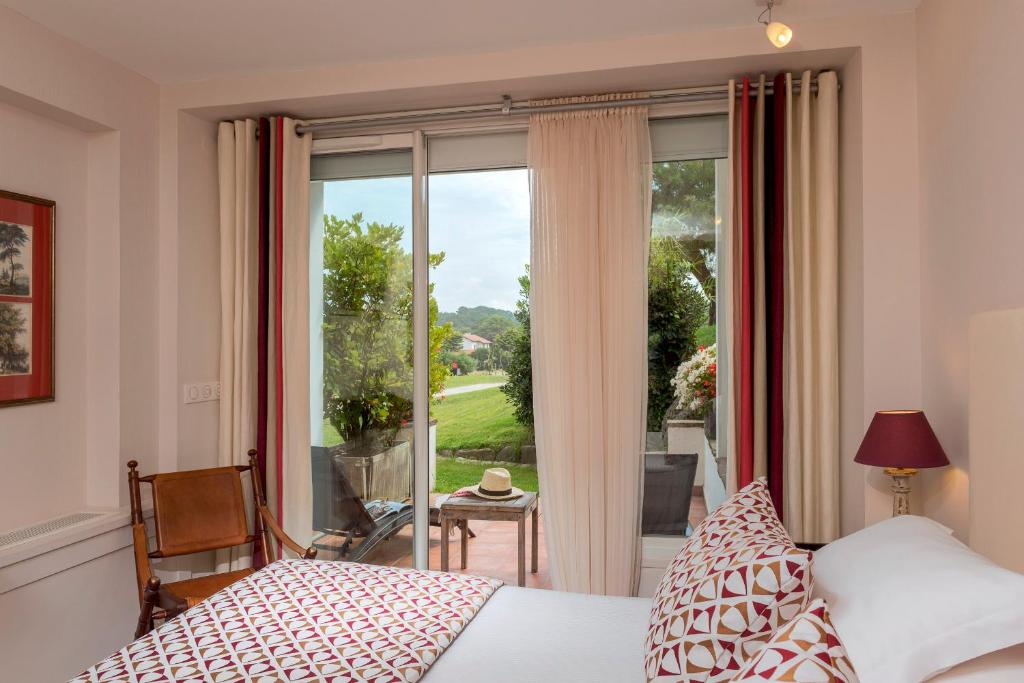 Postel nebo postele na pokoji v ubytování Hôtel La Réserve