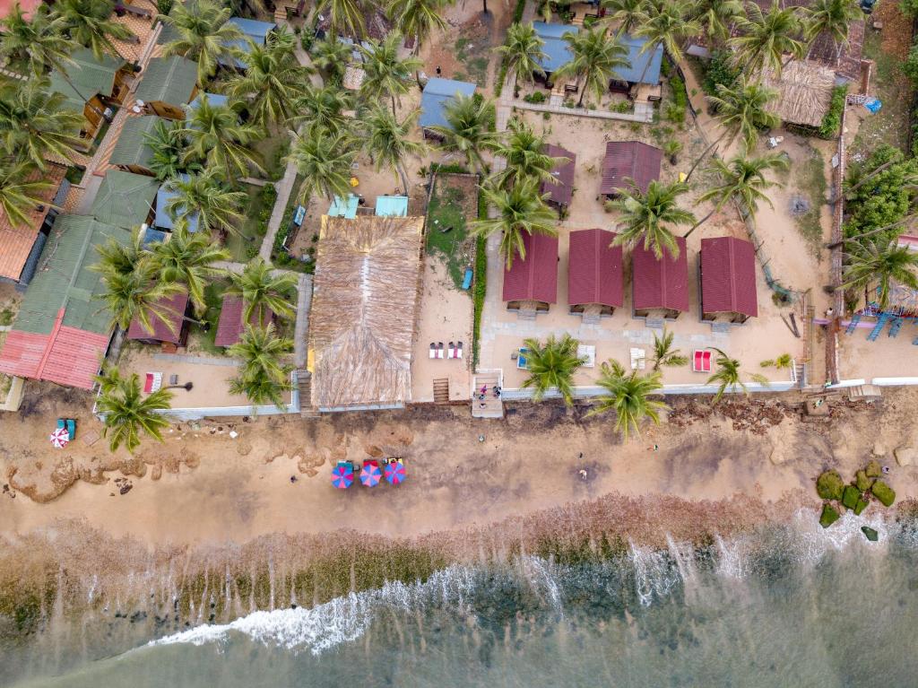 an aerial view of a beach with palm trees at Vista Praia Beach Resort in Anjuna