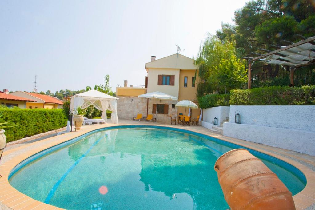 a large swimming pool in front of a house at Bozis Private Pool Villa, Siviri in Siviri