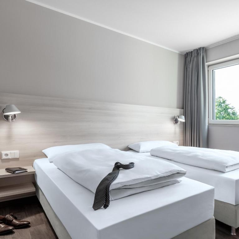 Postel nebo postele na pokoji v ubytování Serways Hotel Lüneburger Heide West