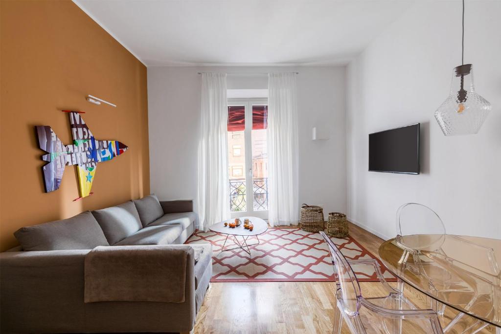 a living room with a couch and a glass table at Residence le Porte - by Adriano Group in Bologna