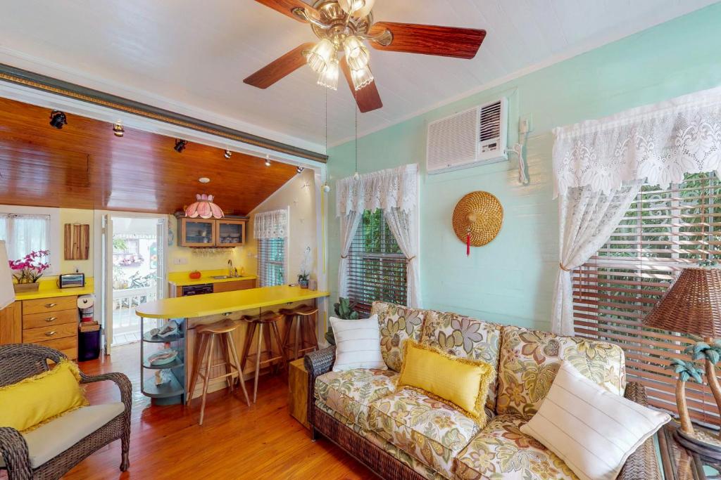a living room with a couch and a kitchen at Gingerbread in Key West
