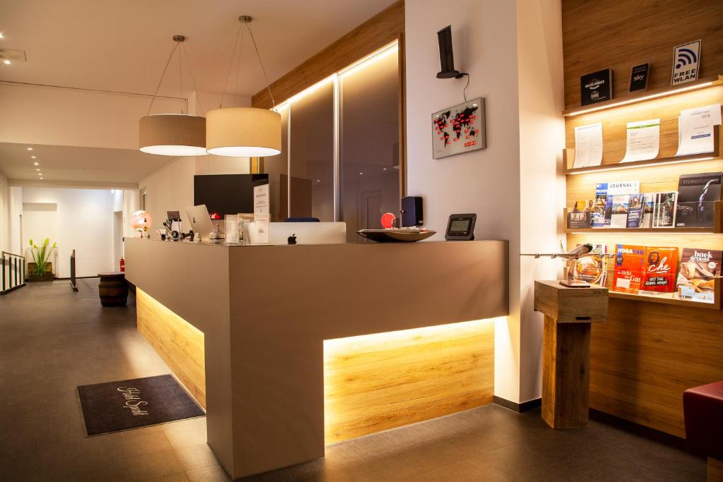 a bar in a restaurant with a counter in a room at Hotel Specht in Dortmund