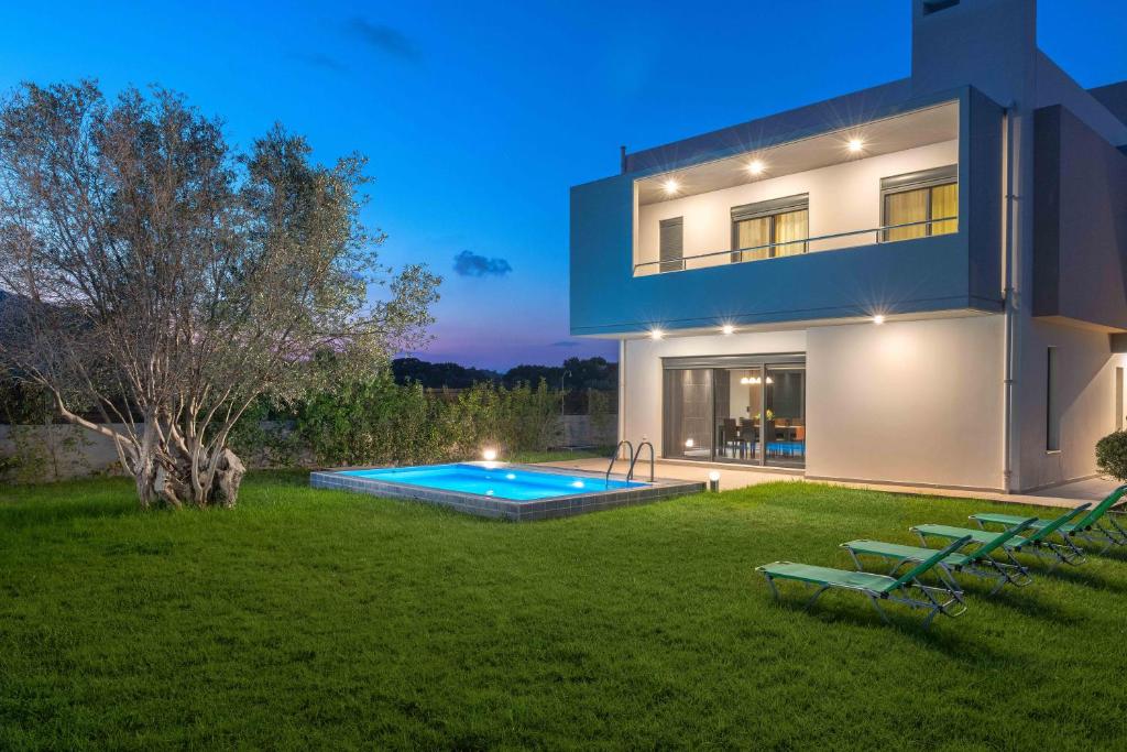 a house with a swimming pool in a yard at Filerimos Garden Villa in Ialyssos