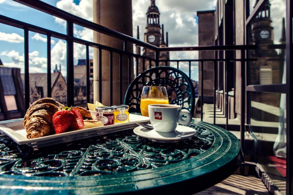 a table with a tray of food and a cup of coffee at Carlton George Hotel in Glasgow
