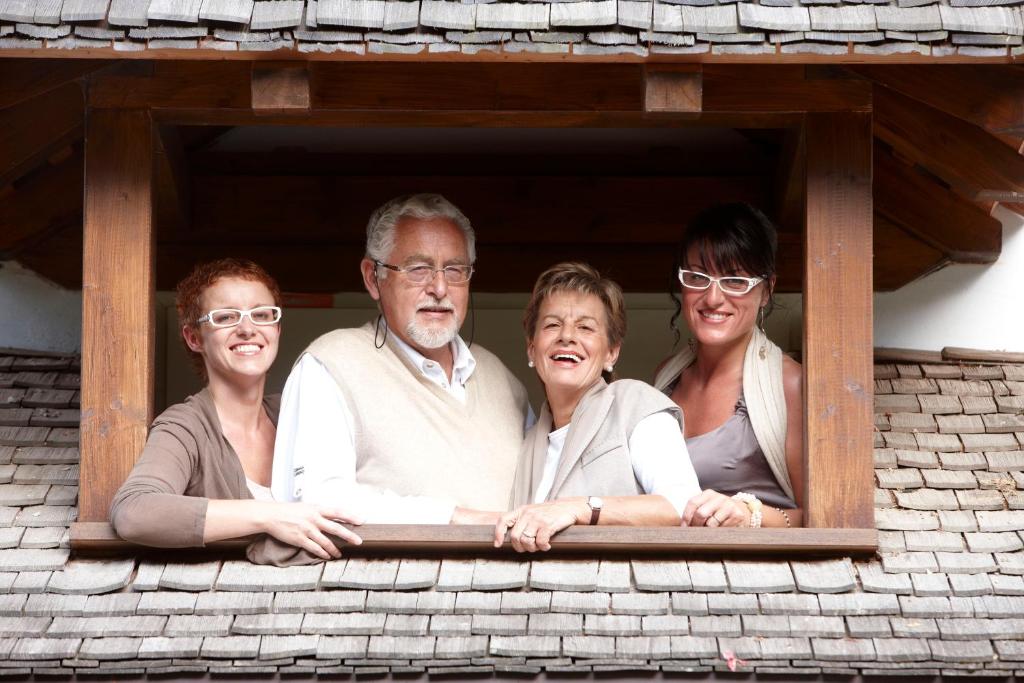a group of people looking out of a window at Bio Hotel Hermitage in Madonna di Campiglio