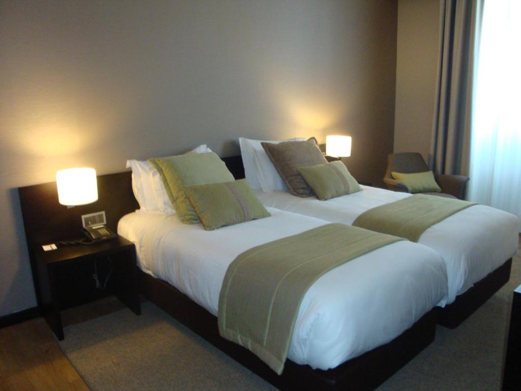 Postel nebo postele na pokoji v ubytování TURIM Aveiro Palace Hotel