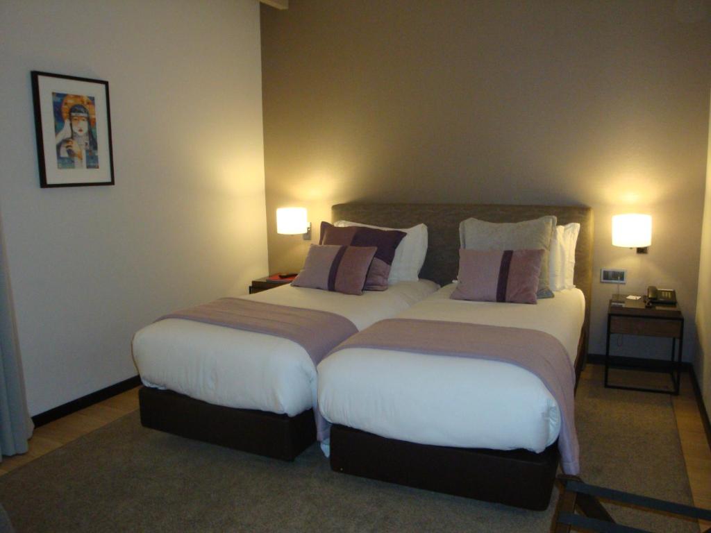 Postel nebo postele na pokoji v ubytování TURIM Aveiro Palace Hotel