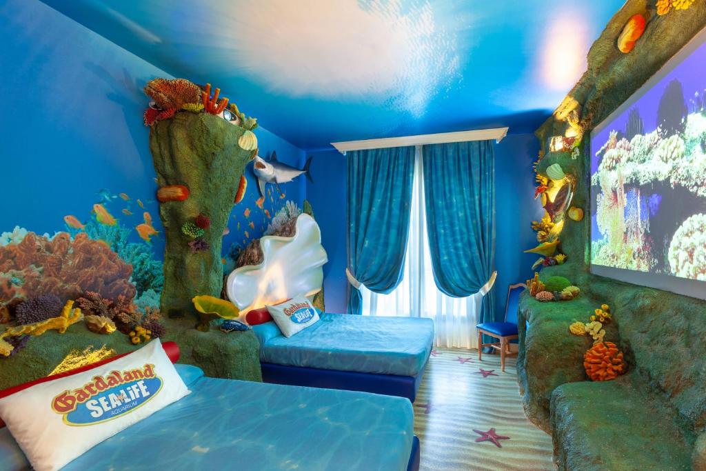 Postel nebo postele na pokoji v ubytování Gardaland Hotel