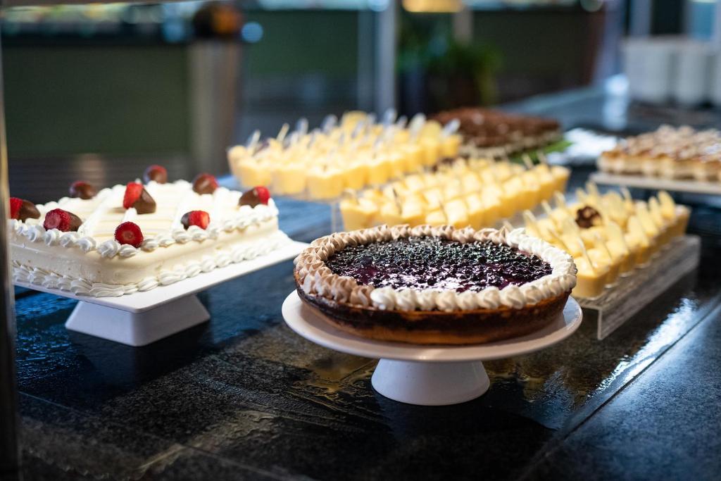 a display of cakes and other desserts on a table at Alexandre Grand Teguise Playa in Costa Teguise