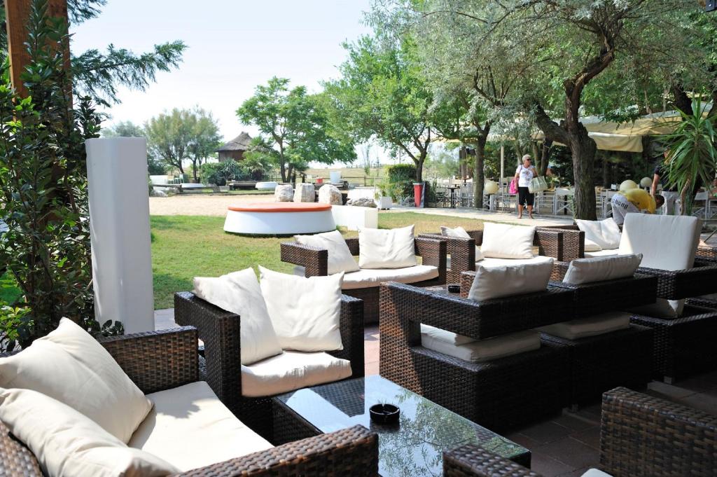 a group of wicker chairs and tables in a park at Hotel Valdor in Cavallino-Treporti