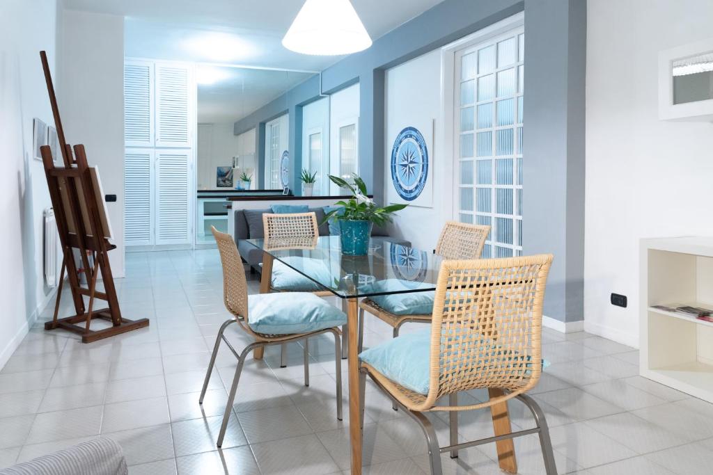 a dining room with a glass table and chairs at Home 41° in Formia