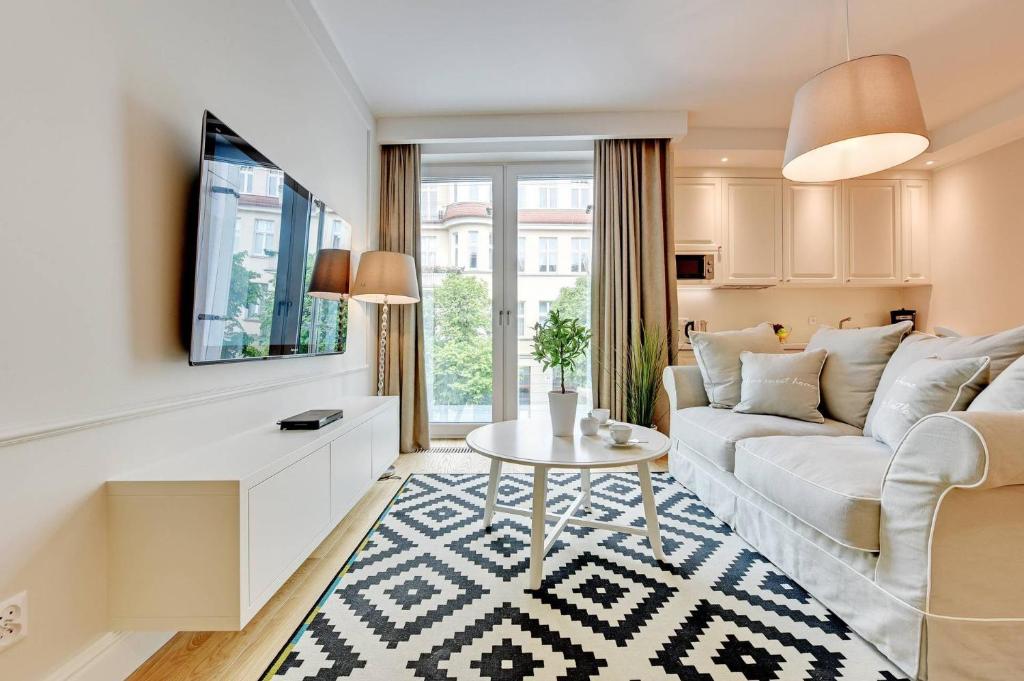a living room with a couch and a table at Montevideo Centrum 4 by Grand Apartments in Sopot