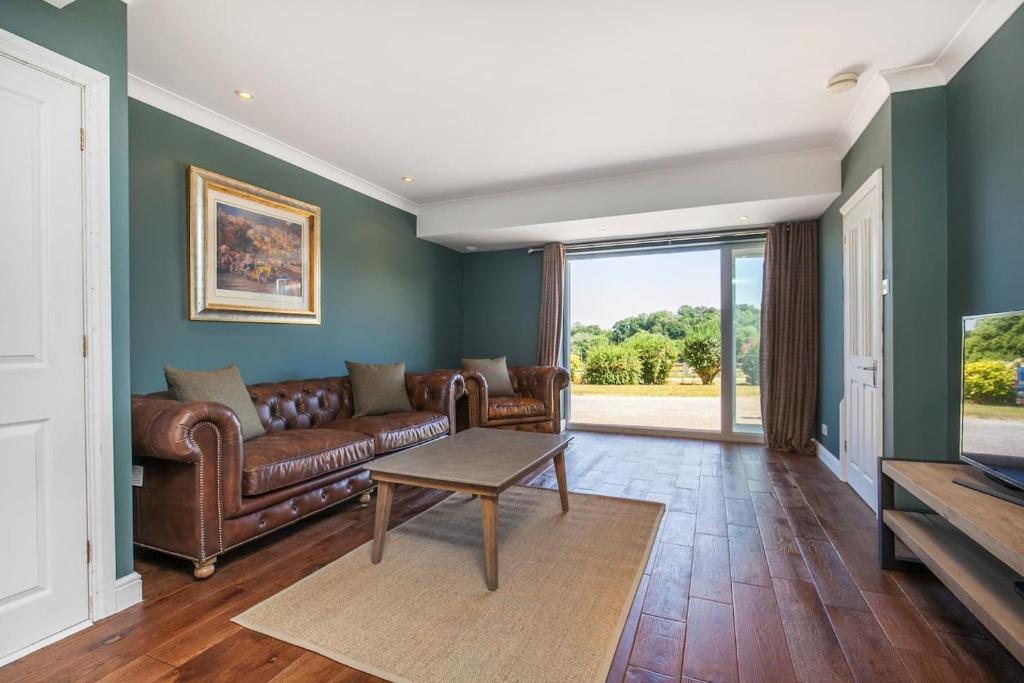 a living room with a couch and a table at Watley Farm in Winchester