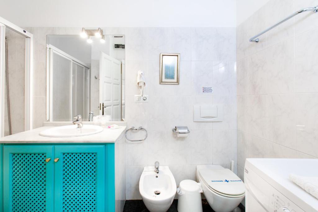 a bathroom with a sink and a toilet at AT Almoraide Rooms Suites in Nerja