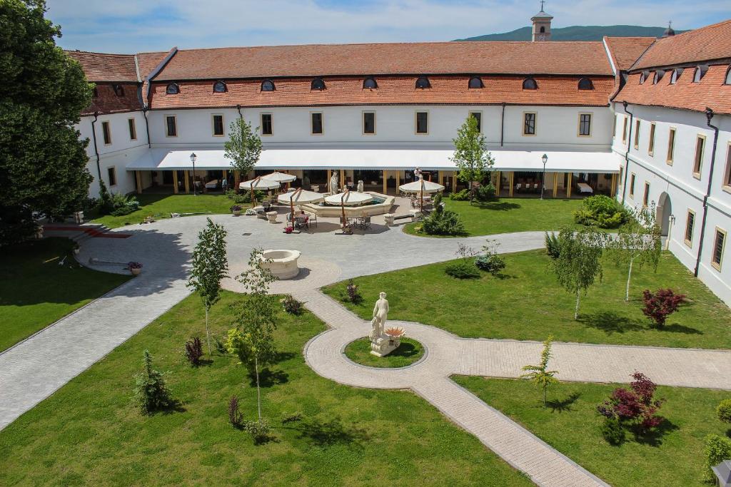 
a large building with a large lawn in front of it at Hotel Medieval in Alba Iulia
