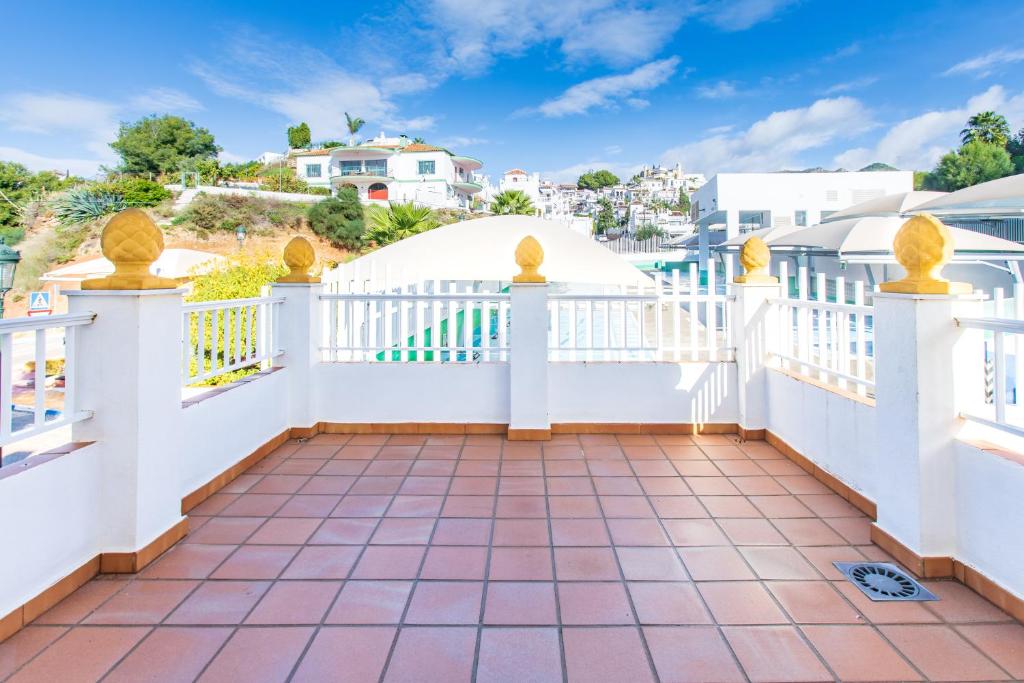 a white balcony with a white fence at AT Almoraide Rooms Suites in Nerja
