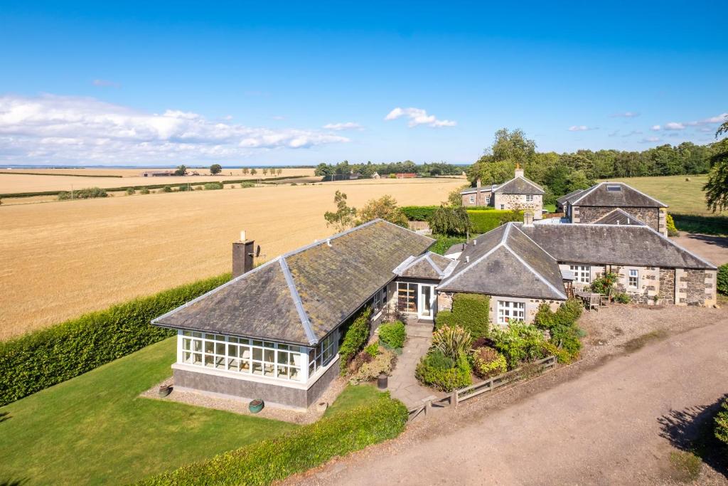 an aerial view of a house with a field at Denbrae Cottage West in St. Andrews