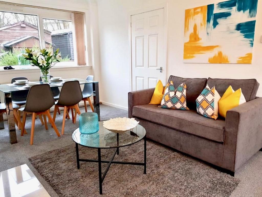 a living room with a couch and a table at South Calder House in Wishaw