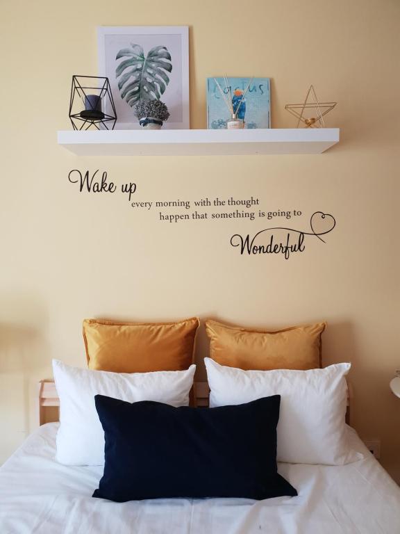 a bedroom with a bed with two shelves above it at DOWNTOWN-Guest House in Olhão