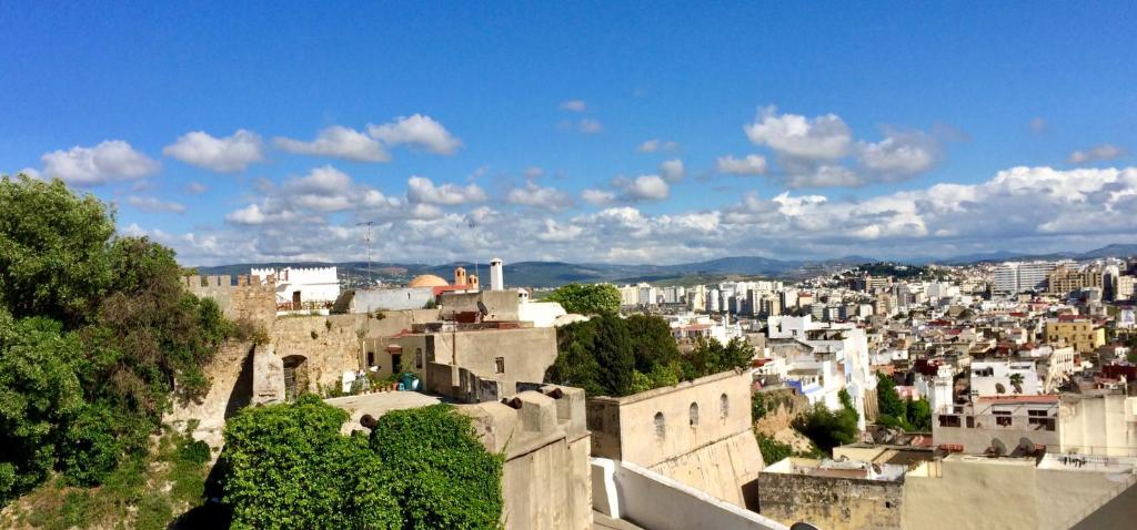 a view of a city with buildings and trees at Dar Sami, Riad Bab Kasbah in Tangier