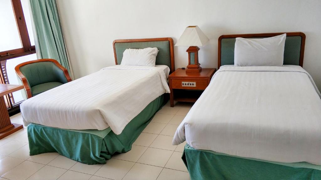 Postel nebo postele na pokoji v ubytování Grand Whiz Hotel Bromo