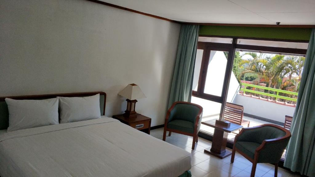Postel nebo postele na pokoji v ubytování Grand Whiz Hotel Bromo