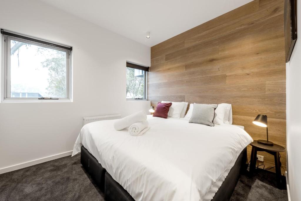 a bedroom with a large bed with a wooden headboard at Elk at Falls in Falls Creek