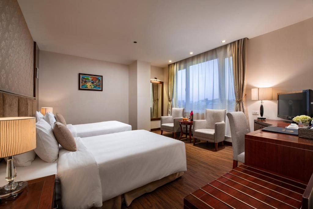 Postel nebo postele na pokoji v ubytování Nesta Hotel Hanoi