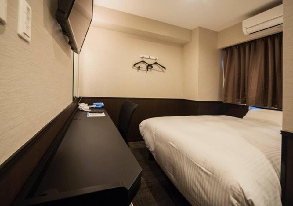 Giường trong phòng chung tại Hotel Excellence Kyoto Station Nishi