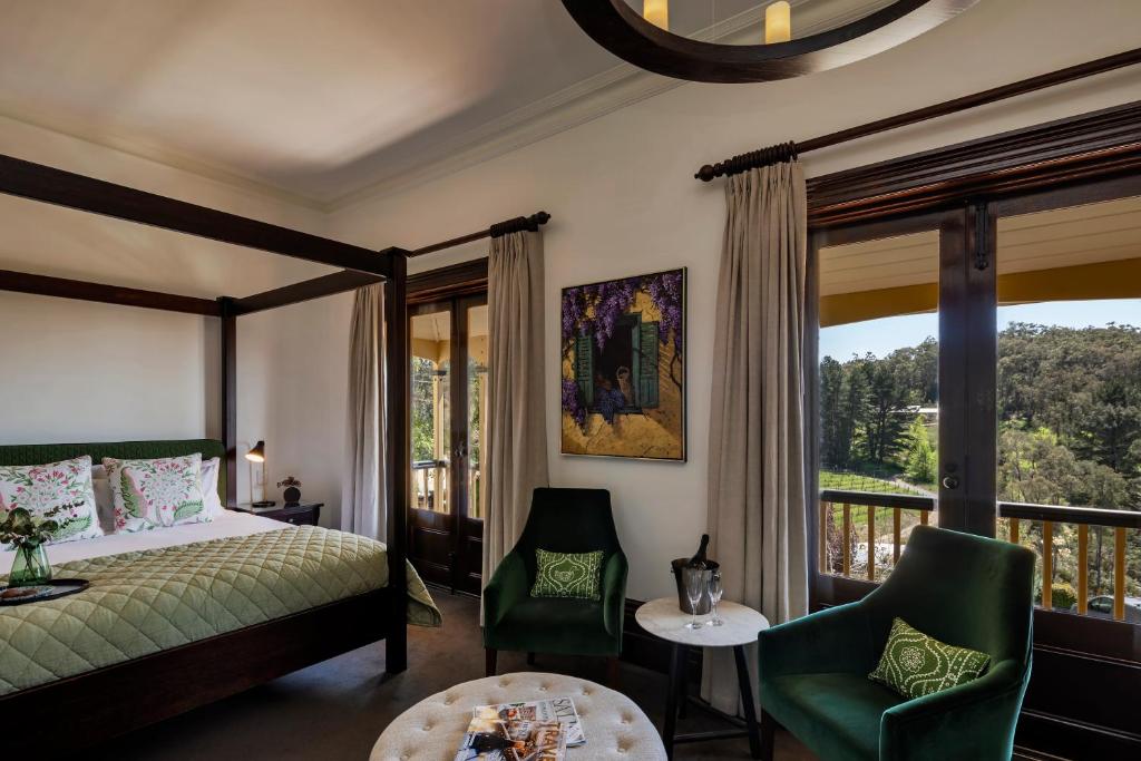 a bedroom with a bed and a balcony at Mount Lofty House in Adelaide