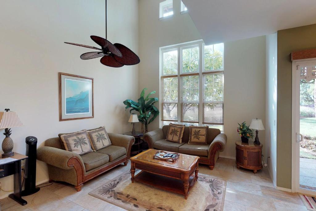 a living room with two couches and a table at Waikoloa Colony Villas #1603 in Waikoloa