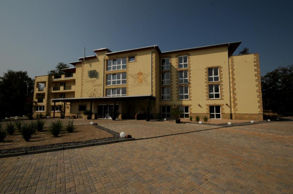 a large building with a brick driveway in front of it at Seehotel Europa in Schwanau