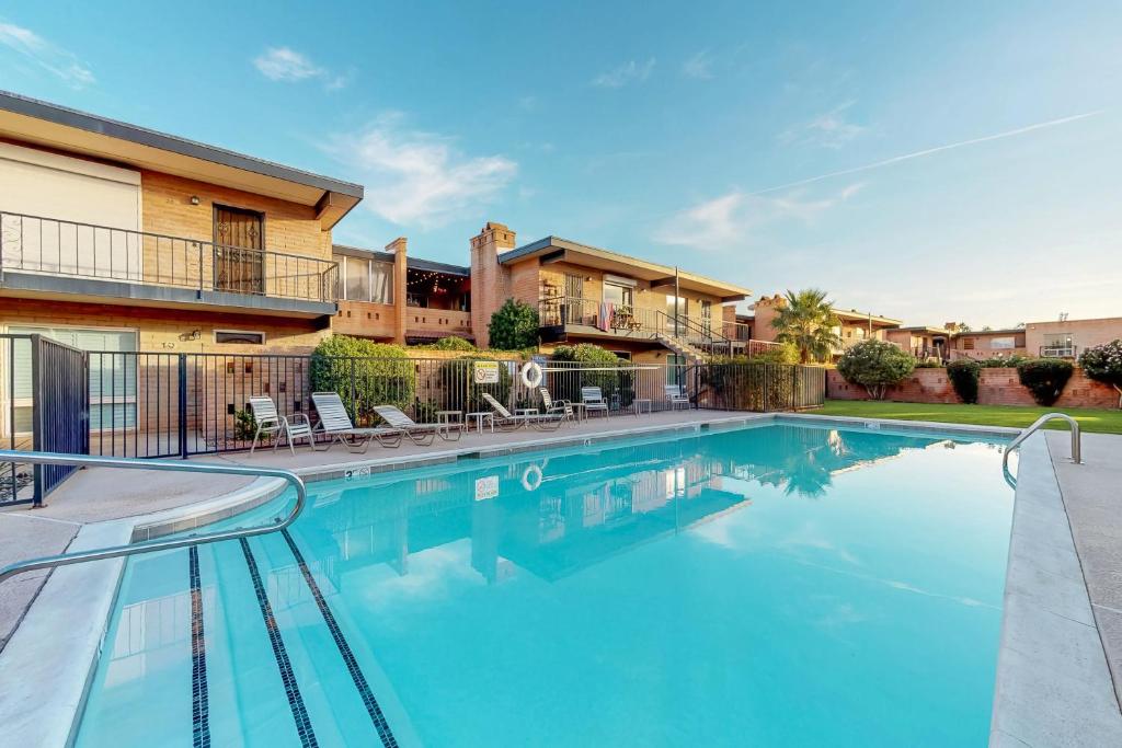 a swimming pool in front of a house at Casa Feliz in Scottsdale