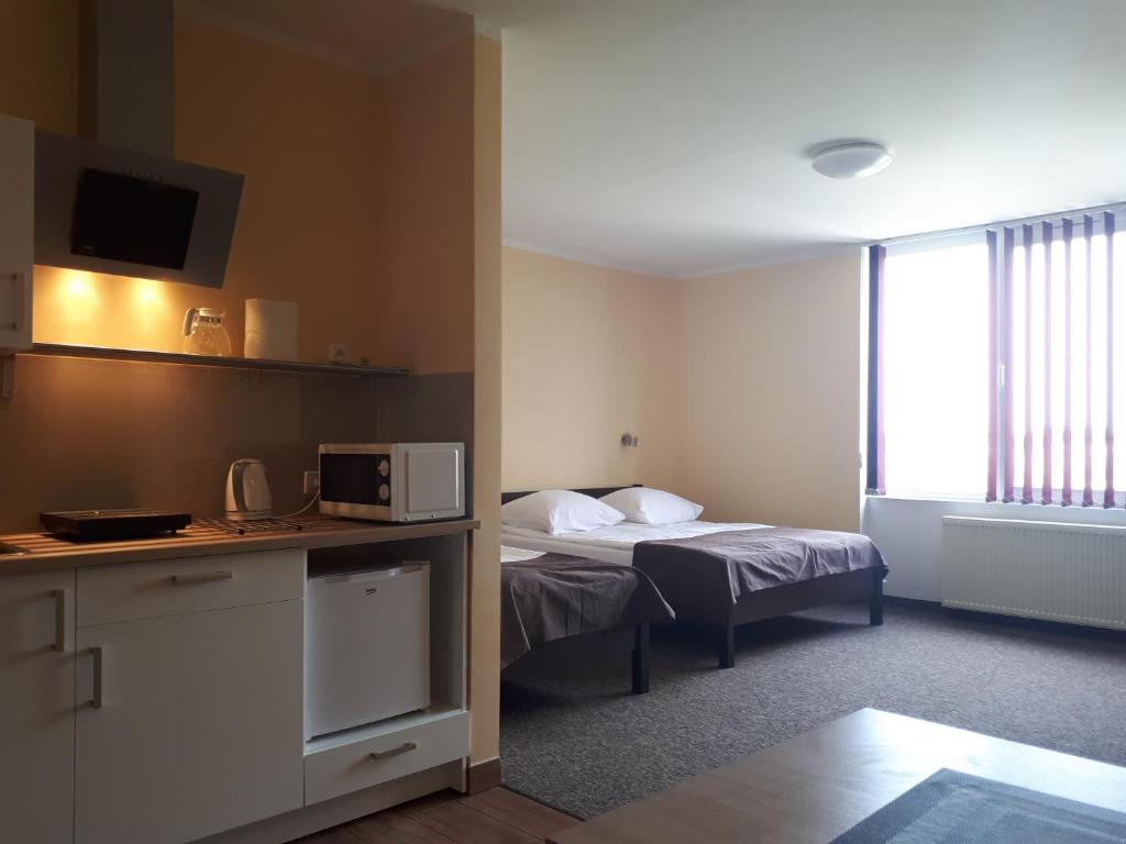 Habitación de hotel con cama y microondas en Noclegi Apro en Gdansk