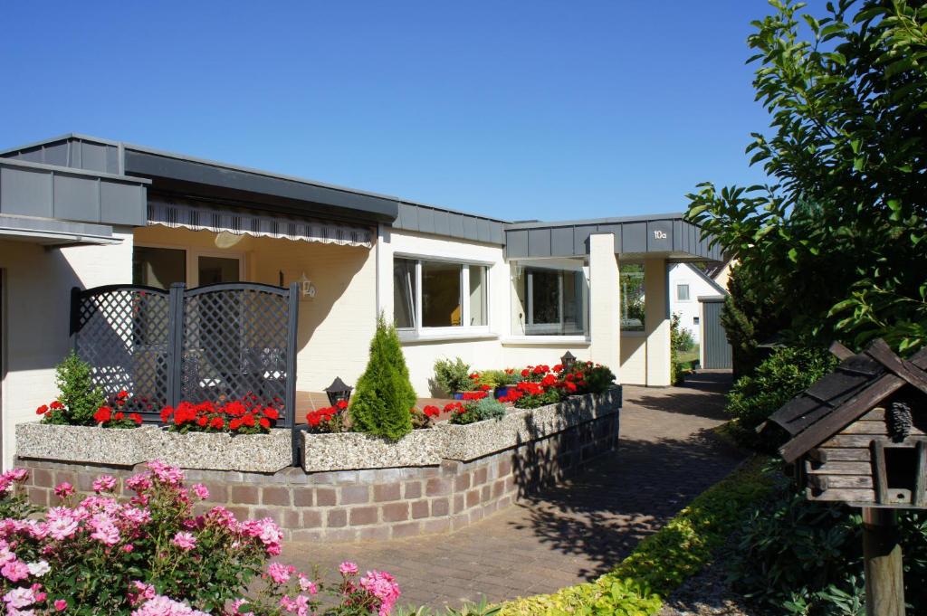 a house with flowers in the front yard at Privatzimmer Sutanto in Reppenstedt