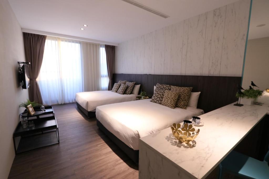 Postel nebo postele na pokoji v ubytování Hotel Hesper HSR Taichung