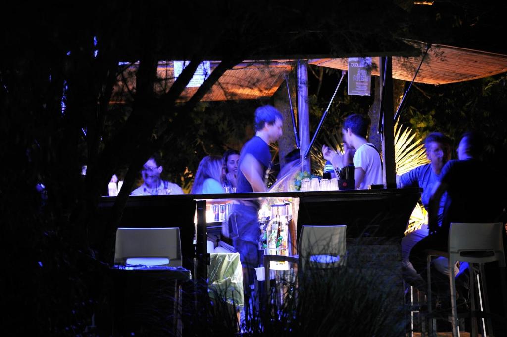 a group of people sitting at a bar at night at Hotel Valdor in Cavallino-Treporti